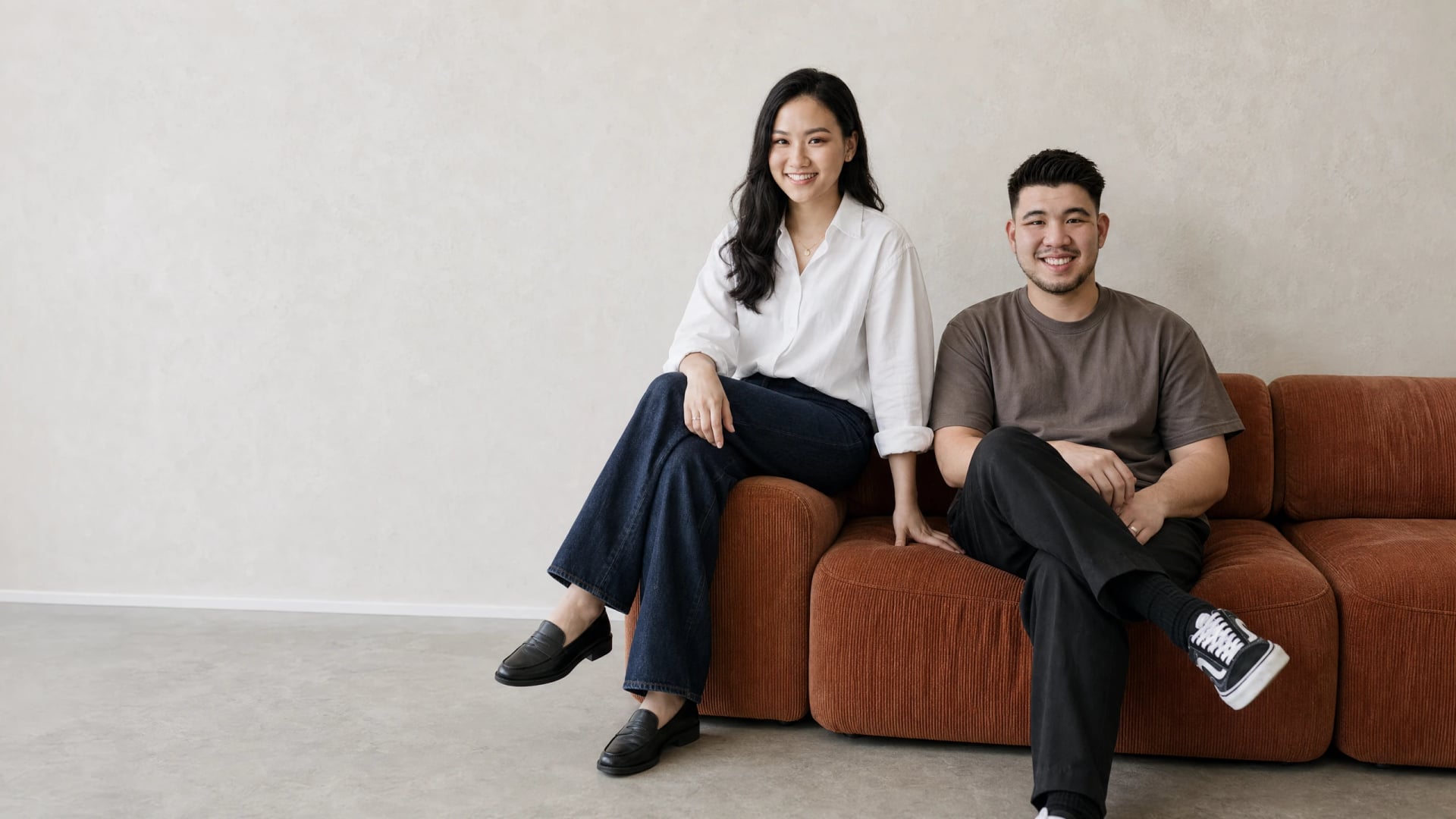 BusyBeeDoc founders sitting together, smiling at the camera