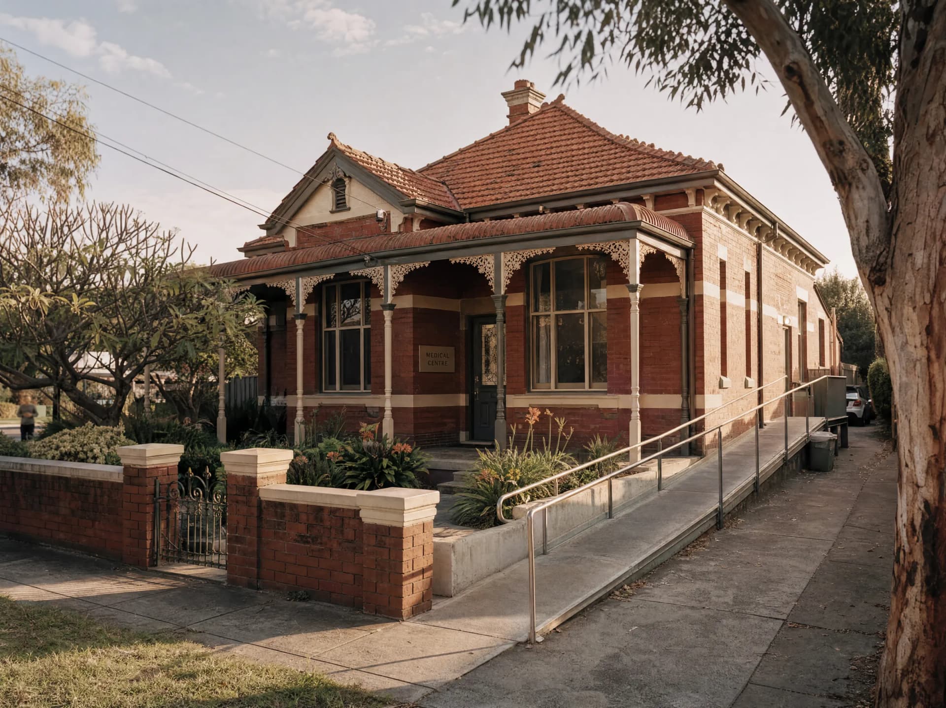A GP clinic in a converted Federation-era brick house, with a wheelchair ramp beside the verandah steps